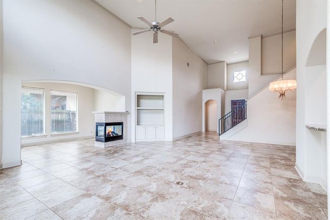 Imagine entertaining in this spacious living area, or cozy evenings home by the fire. Convenient in floor power, and breakfast bar counter top connection to the kitchen. | Image 26