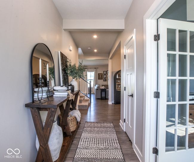 hallway with dark wood-type flooring, arched walkways, and recessed lighting | Image 6
