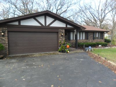 Brick and Cedar Step Ranch with Attached 2 Car Gar | Image 1