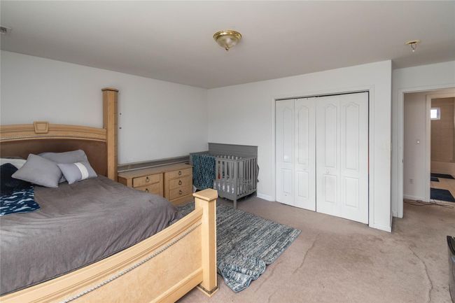 Bedroom featuring visible vents, a closet, carpet floors, and baseboards | Image 40