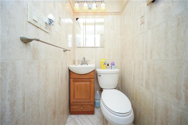 Bathroom with vanity, tile walls, and tile patterned floors | Image 25