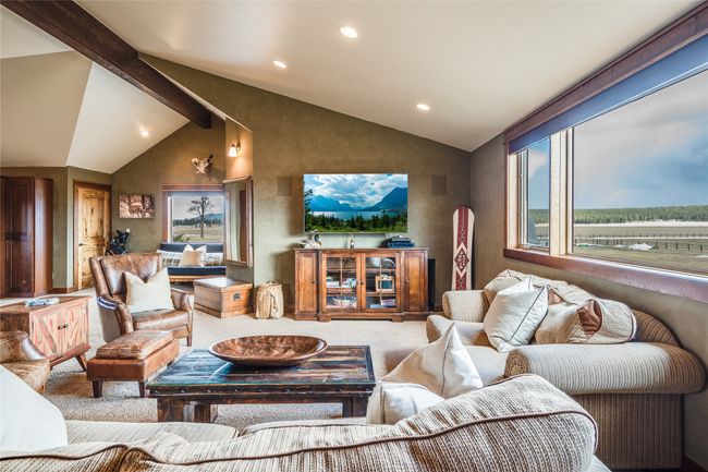 Caretaker Quarters / Guest House. Carpeted living area with recessed lighting and vaulted ceiling with beams | Image 79