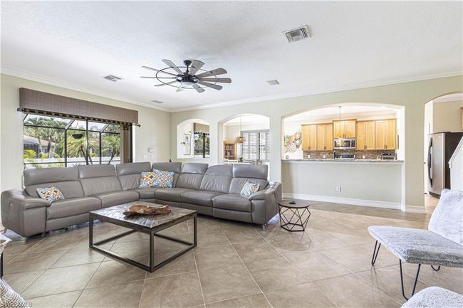 Living area featuring visible vents, a healthy amount of sunlight, and a ceiling fan | Image 8