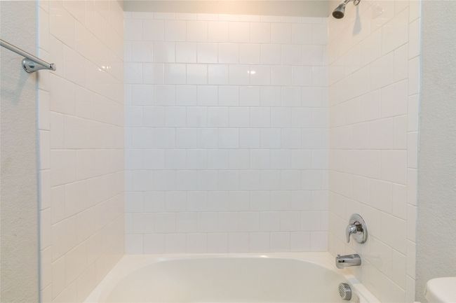 Full bathroom featuring shower / bathtub combination and toilet | Image 31