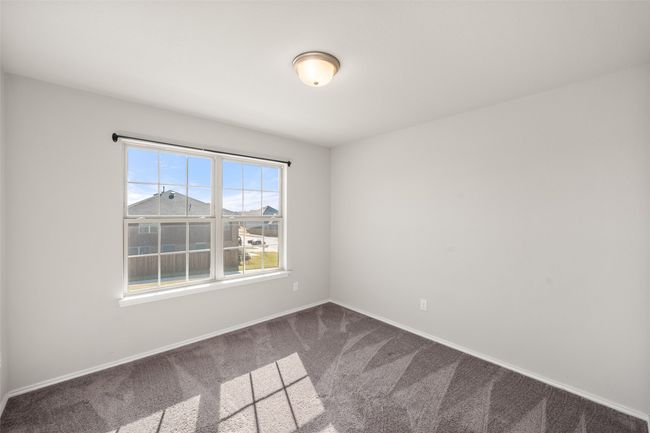 Unfurnished room featuring baseboards and dark colored carpet | Image 15