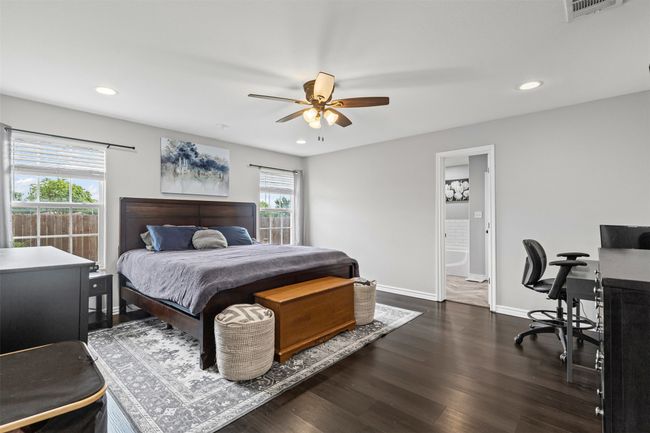 Bedroom featuring multiple windows, recessed lighting, dark wood-type flooring, baseboards, and a desk | Image 17