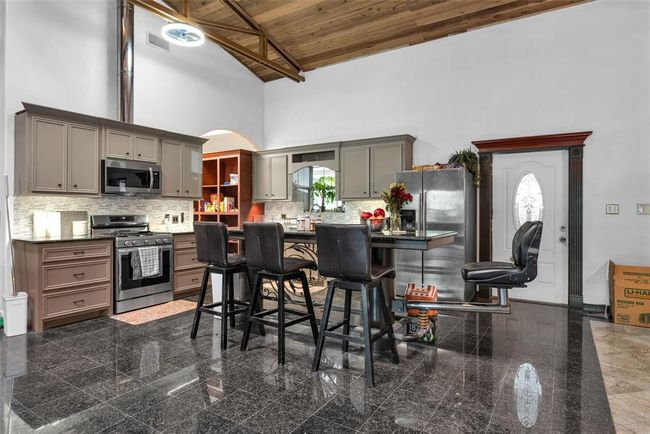 Built in island/bar with under lighting and foot rail | Image 14