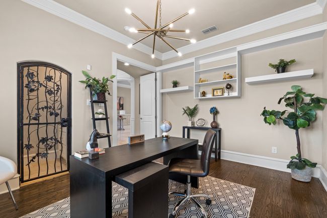 Office space featuring dark wood-type flooring, ornamental molding, a chandelier, and arched walkways | Image 5