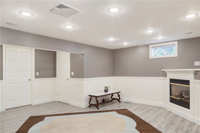 Finished room in basement with fireplace | Image 33