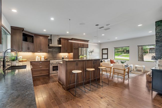 Fully remodeled, this gorgeous modern kitchen comes loaded with desirable modern finishes including built-in stainless steel appliances, granite countertops, subway tile backsplash, and custom cabinetry. | Image 18