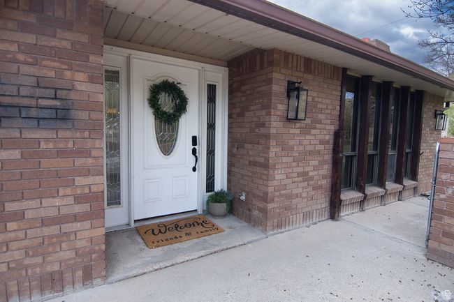 View of exterior entry with brick siding | Image 32