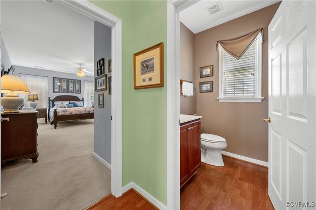 Bathroom with vanity, healthy amount of natural light, a ceiling fan, and wood finished floors | Image 20