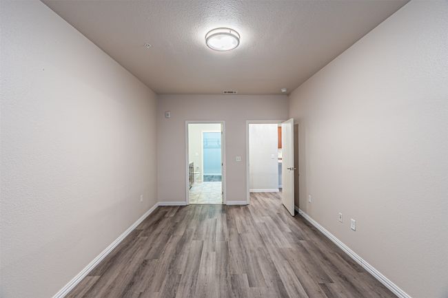 Empty room featuring wood finished floors and a textured ceiling | Image 13