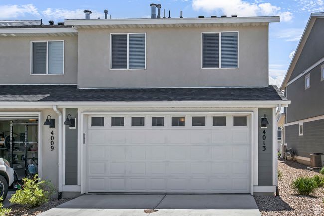 View of front facade featuring a garage, stucco siding, and concrete driveway | Image 4