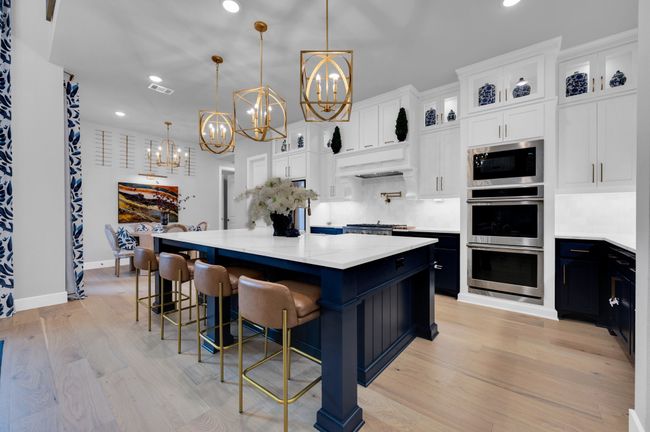 Kitchen with built in microwave, a chandelier, stainless steel double oven, dark cabinetry, and recessed lighting | Image 18