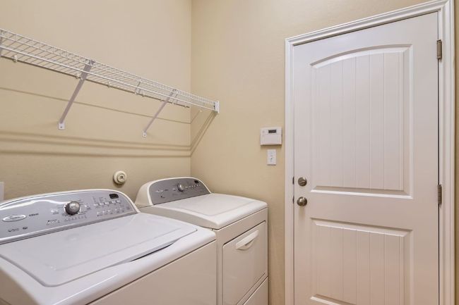 Laundry area featuring washing machine and dryer | Image 25