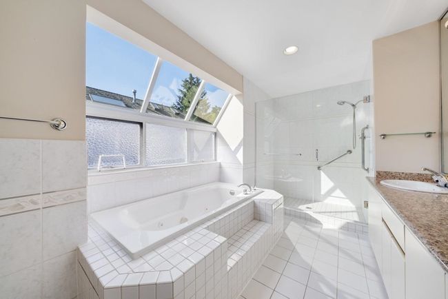 Full bath with tile patterned floors, a stall shower, recessed lighting, a tub with jets, and vanity | Image 24