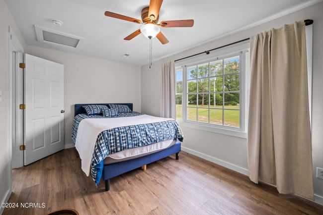 Bright and spacious primary bedroom with ceiling fan for comfort | Image 12