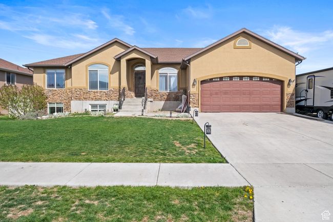 Ranch-style home with a garage, stucco siding, a front yard, and stone siding | Image 41