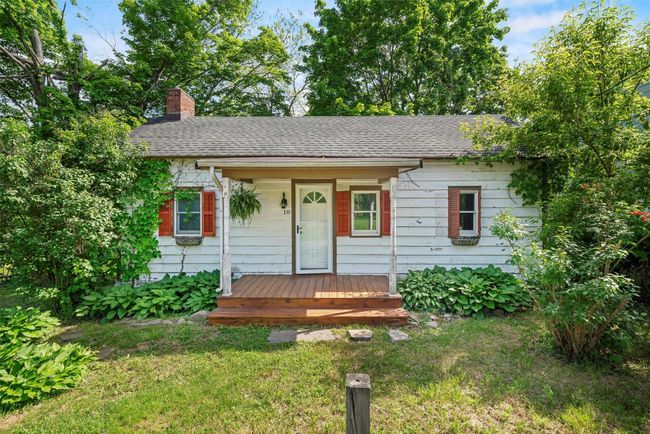 Ranch-style home featuring a chimney, roof with shingles, and a front yard | Image 25