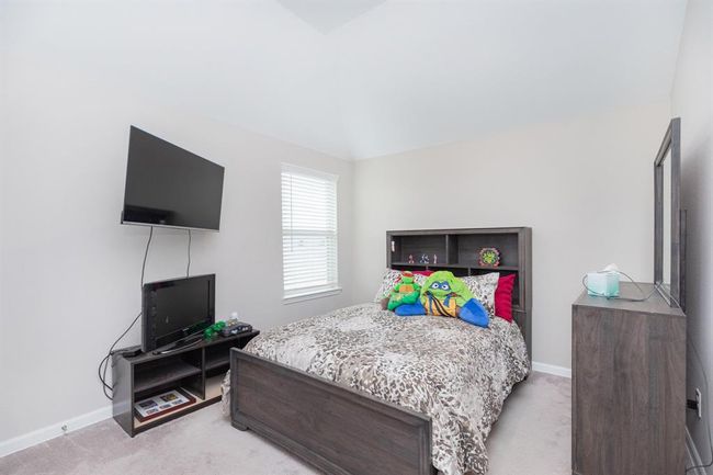 bedroom 3 natural light comes through a window, creating a bright and inviting space. | Image 24