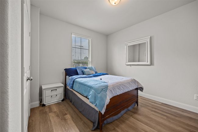 Bedroom featuring wood finished floors and baseboards | Image 23