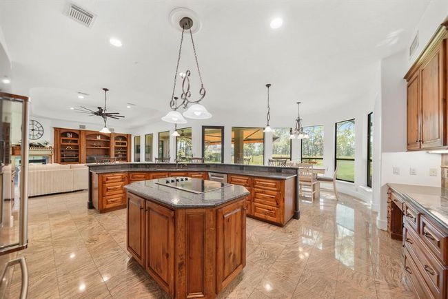 Imagine preparing your favorite meals and recipes in this thoughtfully planned kitchen as your guests mingle about the island, breakfast bar & nearby living areas! | Image 16