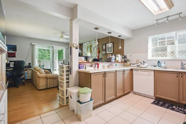 Kitchen featuring dishwasher, a desk, ceiling fan, open floor plan, and pendant lighting | Image 6