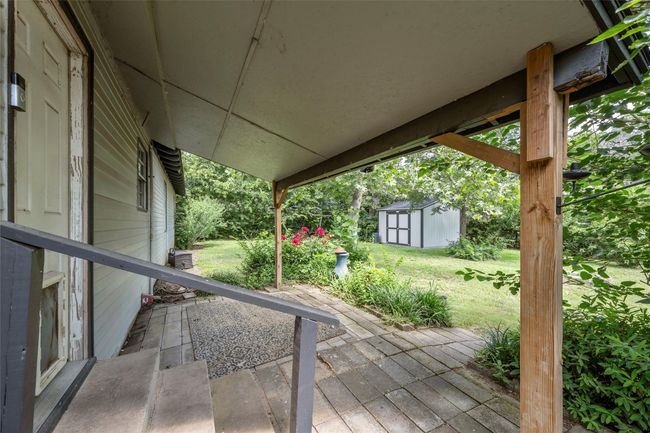 Wooden deck with a storage shed, a yard, and a patio area | Image 17