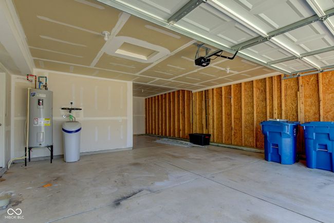 garage featuring water heater and a garage door opener | Image 46