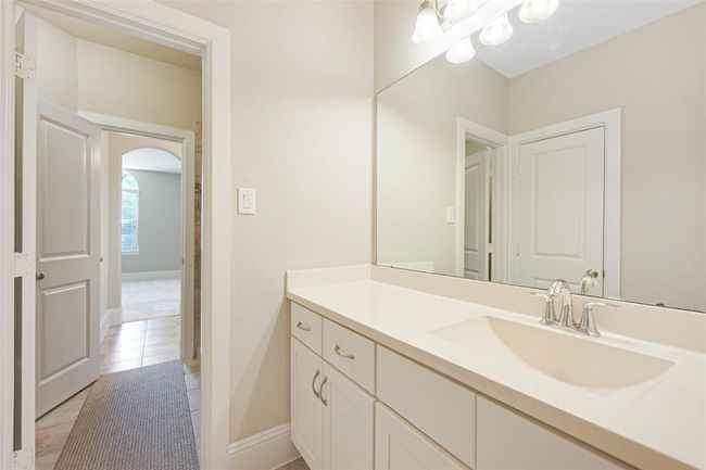 Secondary bathroom with extended vanity, sleek hardware, and neutral tones. Convenient layout with private access from adjoining bedrooms—ideal for shared use or guests. | Image 37