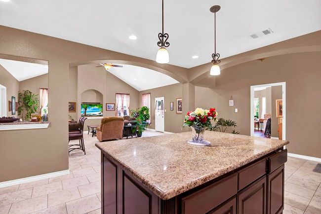 Shown: kitchen center island and living room in background | Image 6