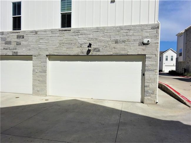 Garage with concrete driveway | Image 18