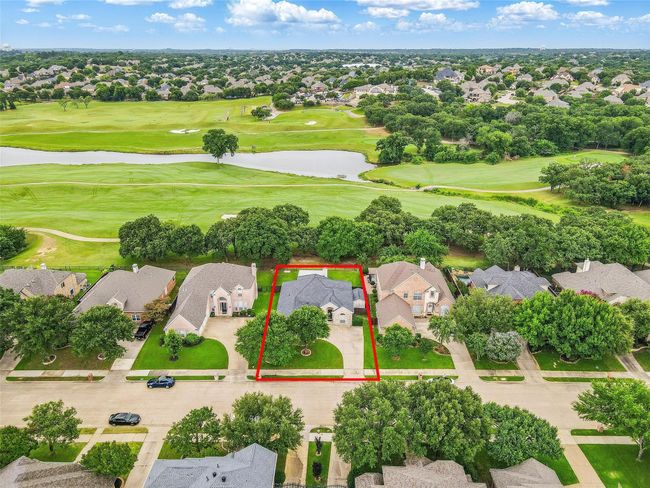 Aerial view of residential area featuring property boundaries highlighted, a golf course, and a large body of water | Image 32