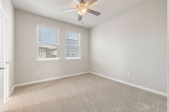 Empty room with light carpet, baseboards, and a ceiling fan | Image 22