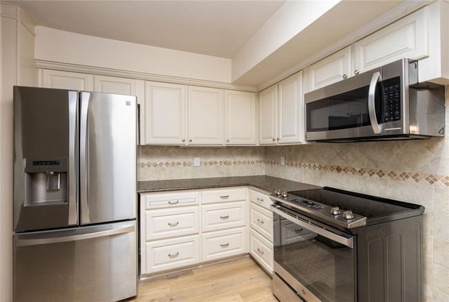 Kitchen has been updated with recent a stainless steel stove, a stainless steel microwave, and a stainless steel refrigerator . | Image 14
