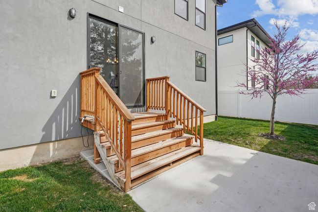 Entrance to property featuring stucco siding, a patio, and a lawn | Image 38