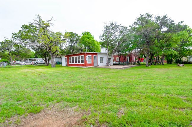 Rear view of property featuring a yard and a patio | Image 4