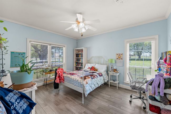 Bedroom with ornamental molding, multiple windows, and wood finished floors | Image 22