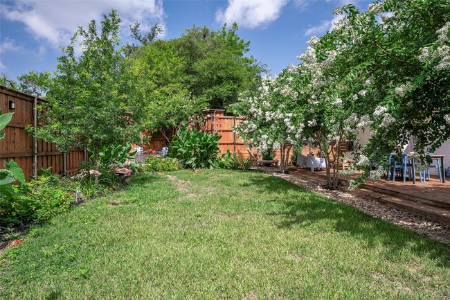 Lush and vibrant backyard offers great space to relax and entertain. | Image 24