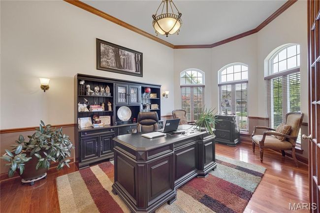 Office with wood finished floors and crown molding | Image 9