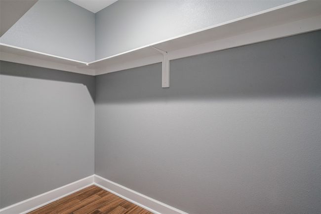 Spacious closet featuring dark wood finished floors | Image 23