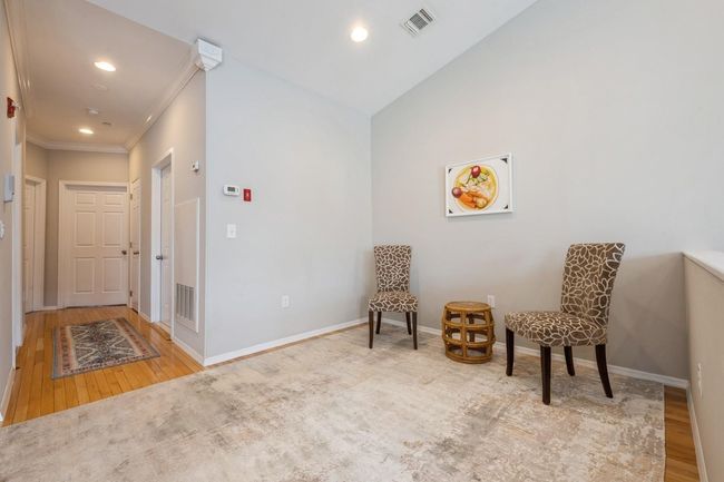 Sitting room featuring baseboards, wood finished floors, and visible vents | Image 9