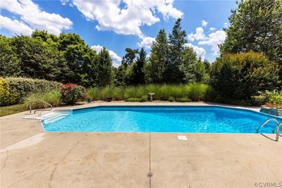 Beautiful landscaping, in-ground pool surrounded by a concrete patio, Trex deck, private back yard, irrigation system, low maintenance vinyl siding, aggregate driveway and a 2 car garage with overhead storage. | Image 3