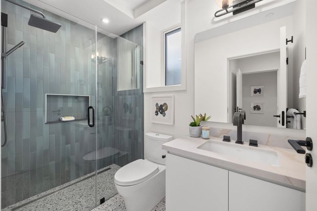 Full bath featuring a stall shower, vanity, recessed lighting, and toilet | Image 14