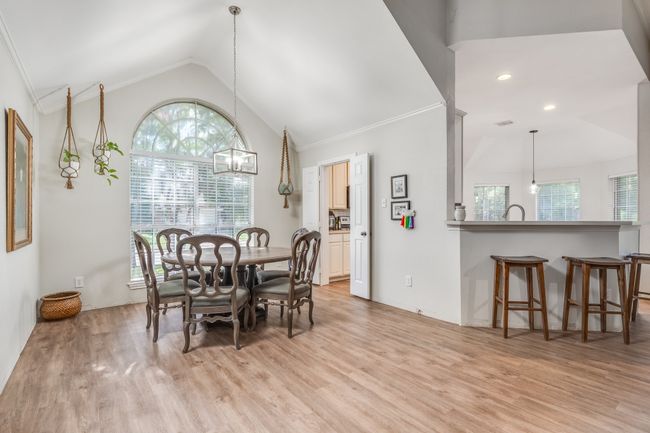 Dining room with light wood-type flooring, healthy amount of natural light, vaulted ceiling, and recessed lighting | Image 17