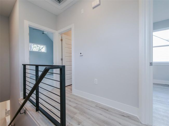 Corridor with an upstairs landing and light wood-type flooring | Image 14