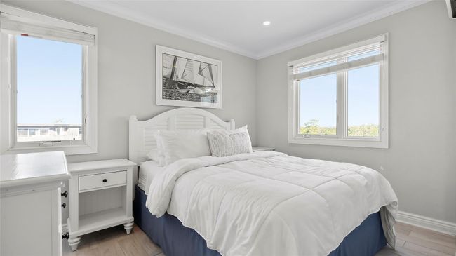 Bedroom with light hardwood / wood-style flooring and ornamental molding | Image 4