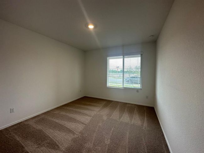 Carpeted empty room featuring baseboards | Image 7