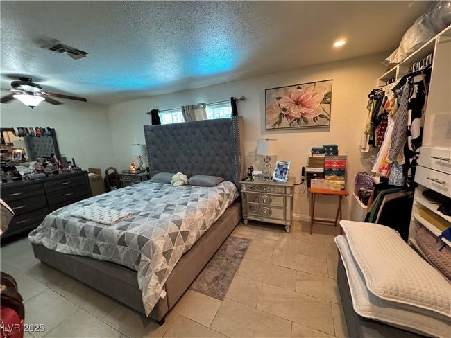 Bedroom with light tile patterned floors, ceiling fan, and recessed lighting | Image 11